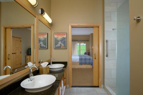a bathroom with two sinks and a shower at Burke Mountain Hotel in East Burke