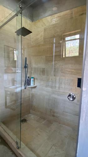 a shower with a glass door in a bathroom at Boutique Loft – Spectacular View – Lake – Mountain in Valle de Bravo
