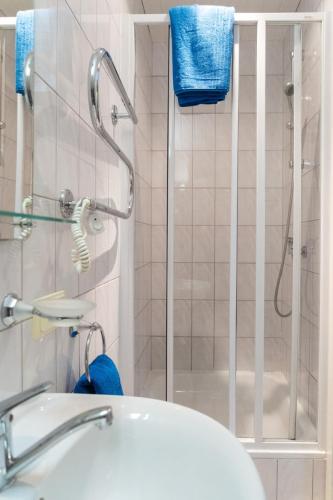 a bathroom with a shower and a white sink at Ema in Palanga