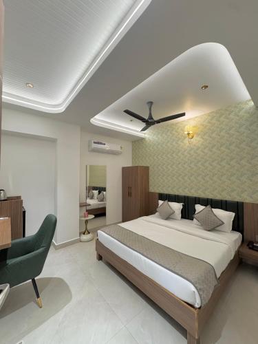 a bedroom with a large bed and a desk at Hotel Meridian in Jagādhri