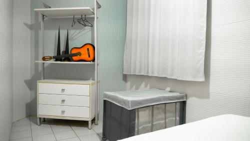 a room with a white dresser and a shelf at Casa das Seringueiras in Alter do Chao
