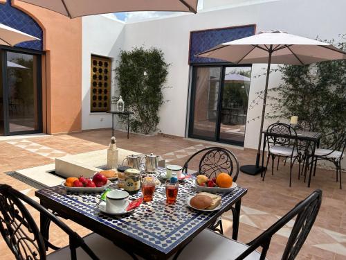 a table with fruit on it on a patio at Patios do Algarve in Ferragudo