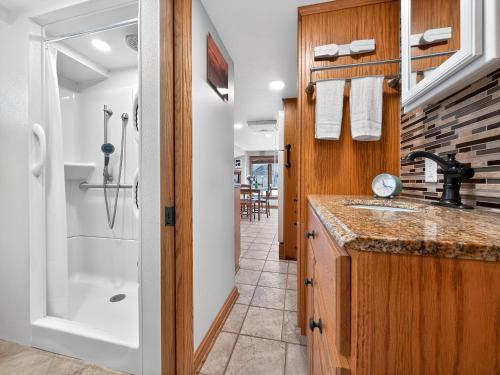 a bathroom with a sink and a shower at Key Largo Tiny House, Marina, Beach, and Pool Access in Key Largo