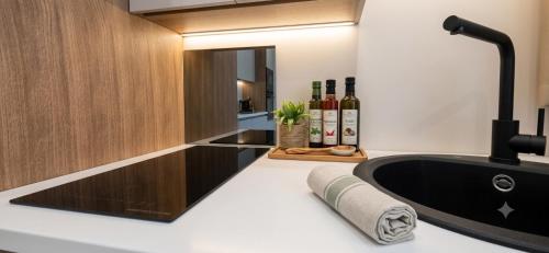 a bathroom with a black tub and a mirror at Salyn Apartments - The Heart of Tropea - Your Perfect Stay in Tropea