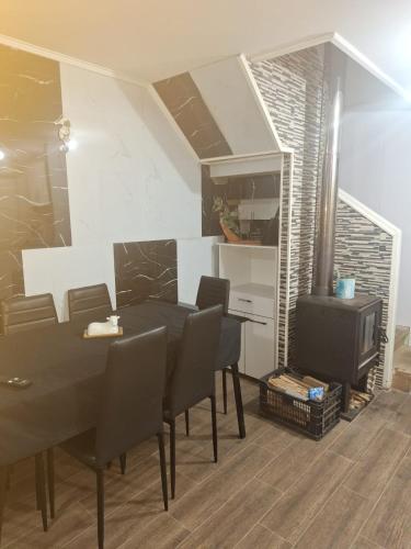 a dining room with a table and a tv at Casa agustina 2 in Valdivia