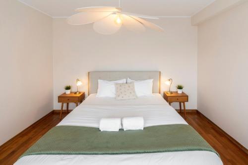 a bedroom with a large white bed with two night stands at Douro View by Porto in Valbom