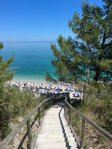 a path leading to a beach with umbrellas at Pietra Museum Suites Sirolo in Sirolo