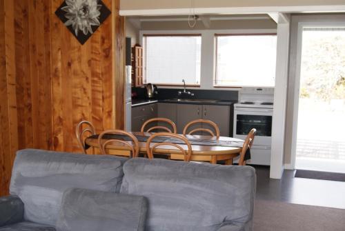 a living room with a couch and a table and chairs at Apostles View Motel in Greymouth