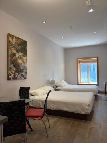 a bedroom with a large bed and a window at Dragon Gate Inn in Toronto
