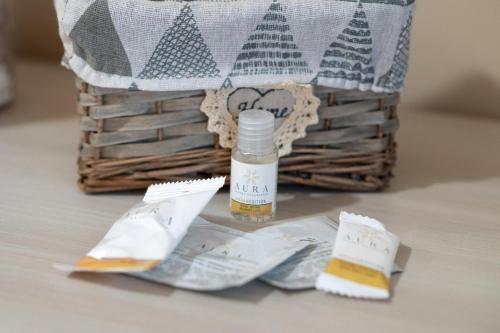 a bottle of essential oil sitting next to a basket at B&B Civico 15 in Nettuno