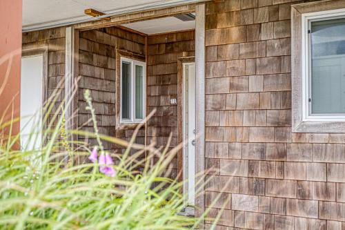 a wooden house with a door and windows at Pacific Sands Unit #10 in Neskowin