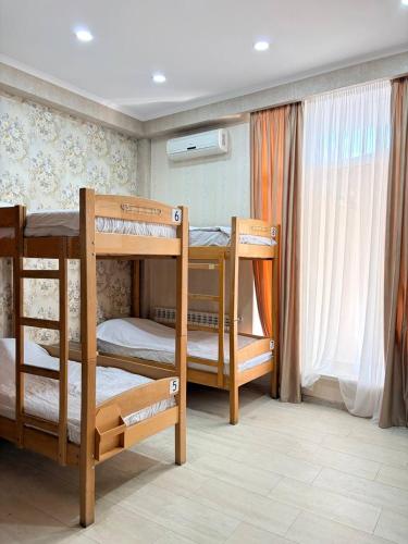 a room with three bunk beds in a room at Suli Hostel in Tbilisi City