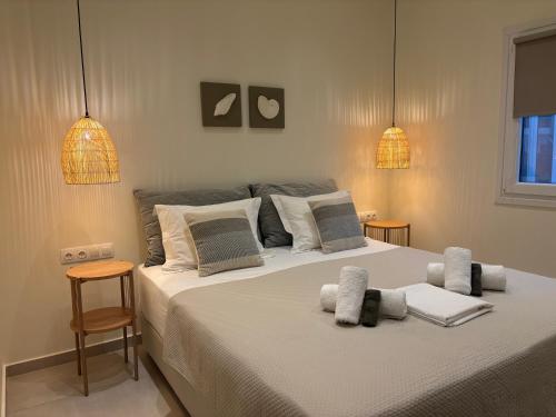 a bedroom with a large bed with two lights at EuGeniaS Villa in Agios Gordios