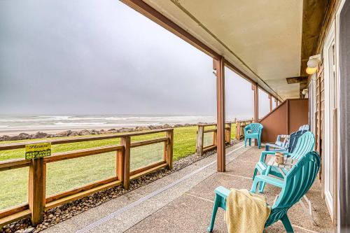 a porch with chairs and a view of the ocean at Waveside Hideaway, Unit 11 in Neskowin