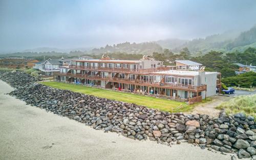 an aerial view of a building next to a rock wall at Waveside Hideaway, Unit 11 in Neskowin