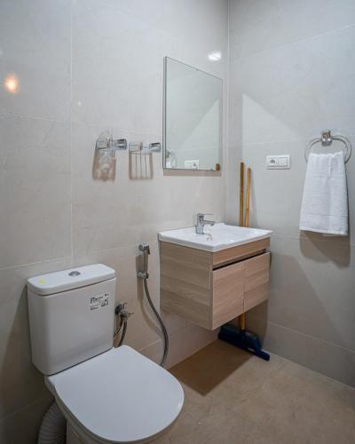 a bathroom with a white toilet and a sink at Sahoria Stay in Dakhla