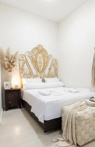 a bedroom with a large bed with white sheets at Halil Bey Luxury Apartments in Kavála