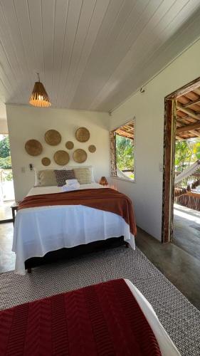 a bedroom with a large bed in a room at Zen Spa Caraíva in Caraíva