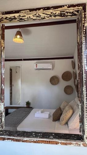 a mirror reflection of a bed in a room at Zen Spa Caraíva in Caraíva