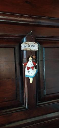 a door with a welcome sign hanging on it at TheA Upper Blue in Kyparissia