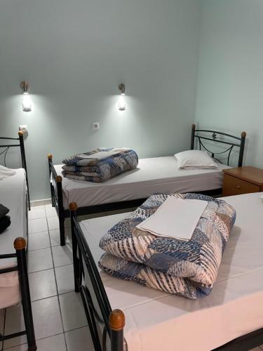 a room with three beds in a room at SAN REMO HOSTEL in Athens