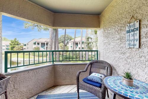 a balcony with a table and chairs and a window at Anchorage 7473 in Hilton Head Island