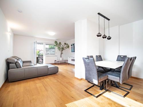 a living room with a dining room table and chairs at Grand Family Residence Ljubljana in Ljubljana