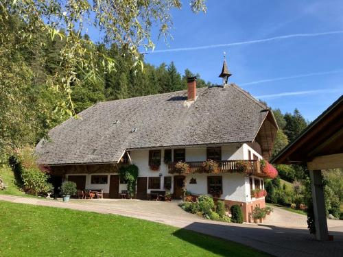 a large white house with a gray roof at Obergießhof Waldbauernhof in Hornberg