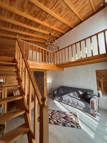 a living room with a staircase and a couch at EM-BA BUTİK BUNGALOV in Demre