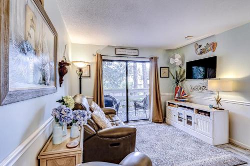 a living room with a couch and a television at Fiddlers Cove 18B in Hilton Head Island