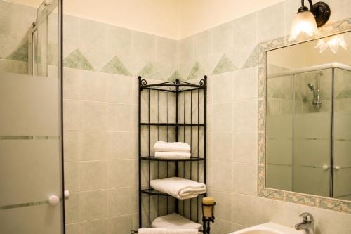 a bathroom with a towel rack next to a sink at All'Ombra della Torre a due passi da Piazza del Campo in Siena