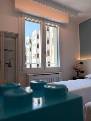 a bedroom with a bed and a window with a building at Bed & Bricks in Reggio Emilia