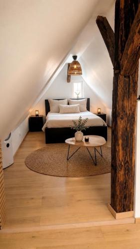 a bedroom with a bed and a table at House in Obernai in Obernai