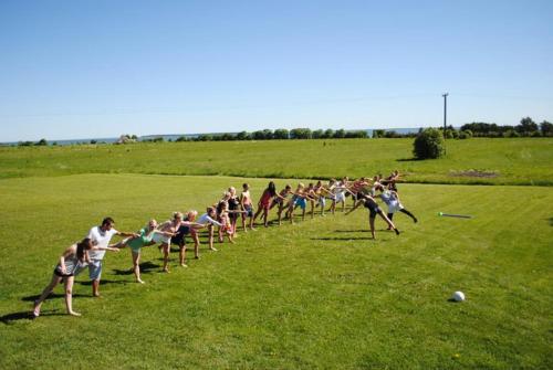 a group of people playing a game in a field at Kuivastujaani in Kuivastu