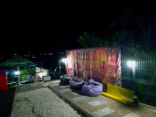 a wall with a group of chairs in front of it at night at DiBosco House in Dubova