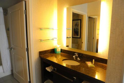 a bathroom with a sink and a large mirror at Residence Inn by Marriott Long Island Islip/Courthouse Complex in Central Islip