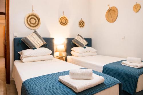 a room with two beds with towels on them at Indaba Luxury Apartments in Myrina