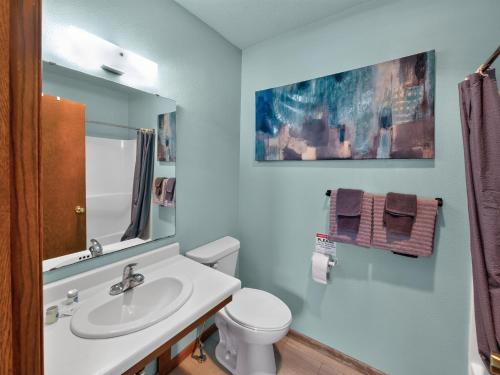 a bathroom with a white toilet and a sink at Clara City Inn in Clara City