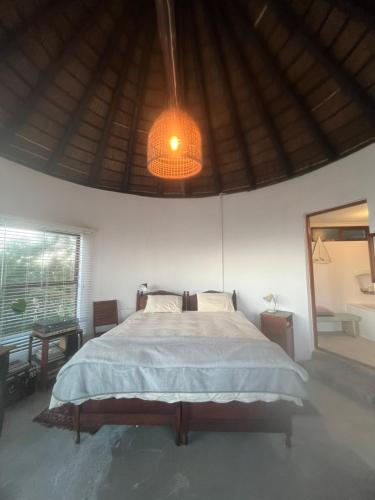 a bedroom with a bed and a light fixture at Rondawel with sea view in Kleinmond