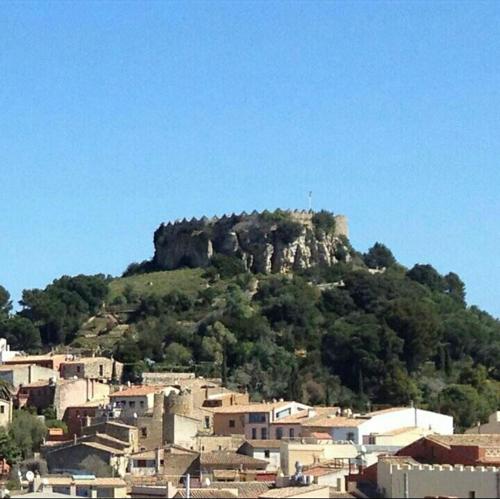 a town with a mountain in the background with houses at Hostal Ondina in Begur