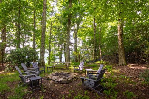 a group of chairs sitting around a fire pit at Blue View Chalet in Blowing Rock