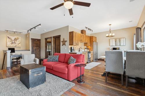 a living room with a red couch and a kitchen at Cana Loft 301 in Whitefish