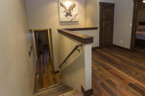 a staircase in a home with wooden floors at Cana Loft 301 in Whitefish