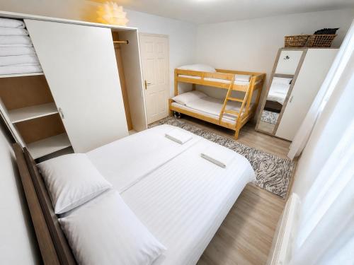 a small room with a bed and bunk beds at Apartman Bambi Vlašić in Vlasic