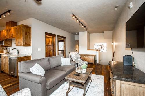 a living room with a couch and a table at Cana Loft 302 in Whitefish