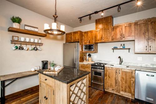 a kitchen with wooden cabinets and stainless steel appliances at Cana Loft 302 in Whitefish