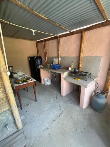 a room with two benches and a table in a tent at Taroland in Máncora