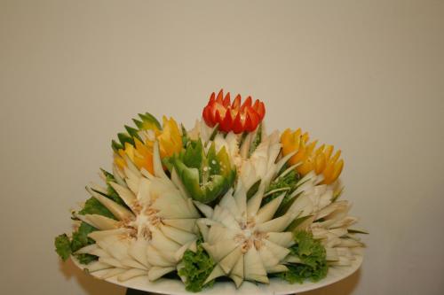 a bouquet of colorful flowers on a plate at Goldi Sands Hotel in Negombo