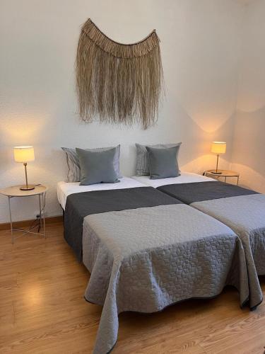 a bedroom with two beds and two tables with lamps at Apartamento Carmen in Macastre