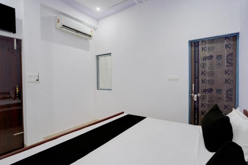 a room with a bed and a window and a door at Hotel O AVS Inn in Bheta